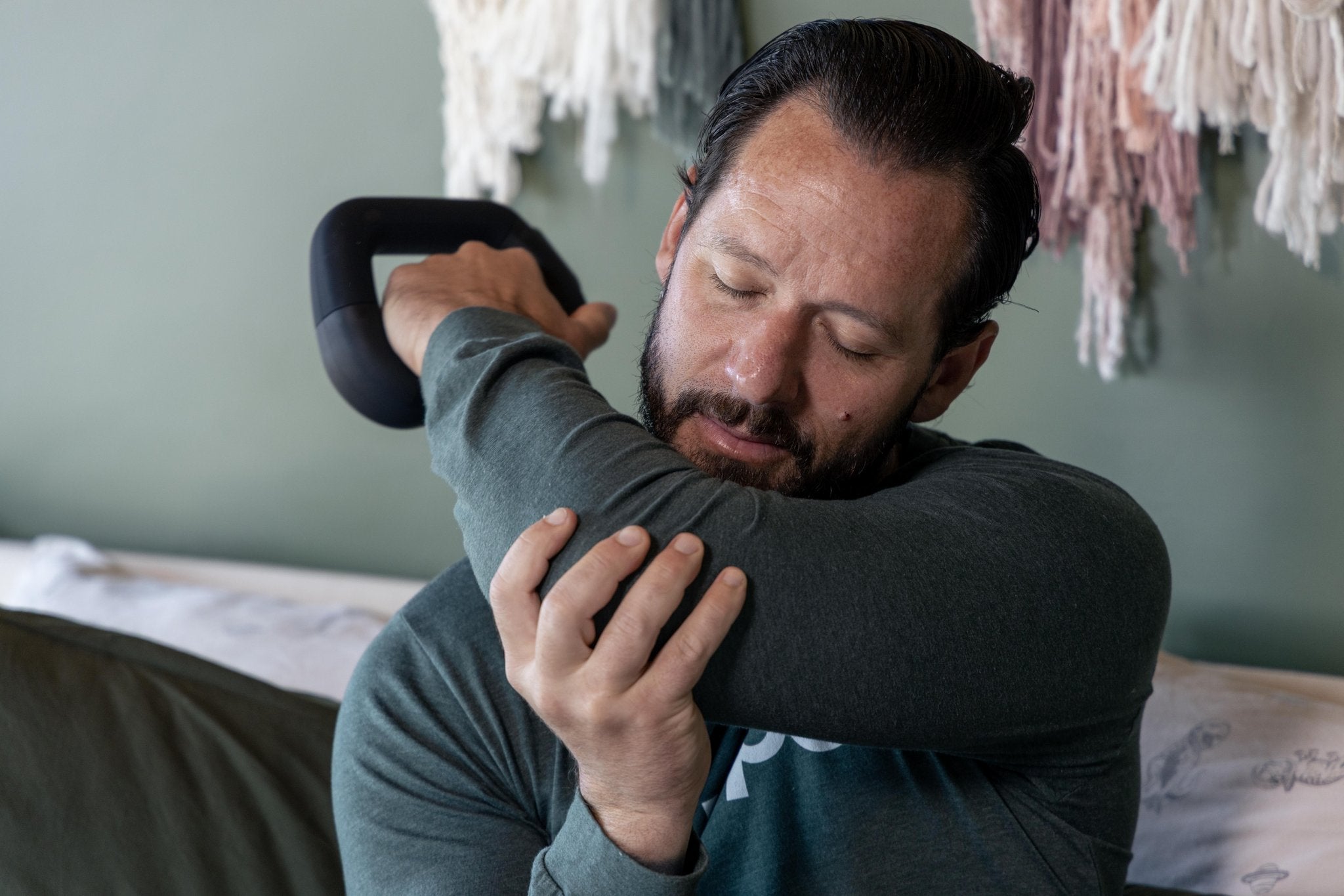 Tyler Using WeRevive percussion massage device up close