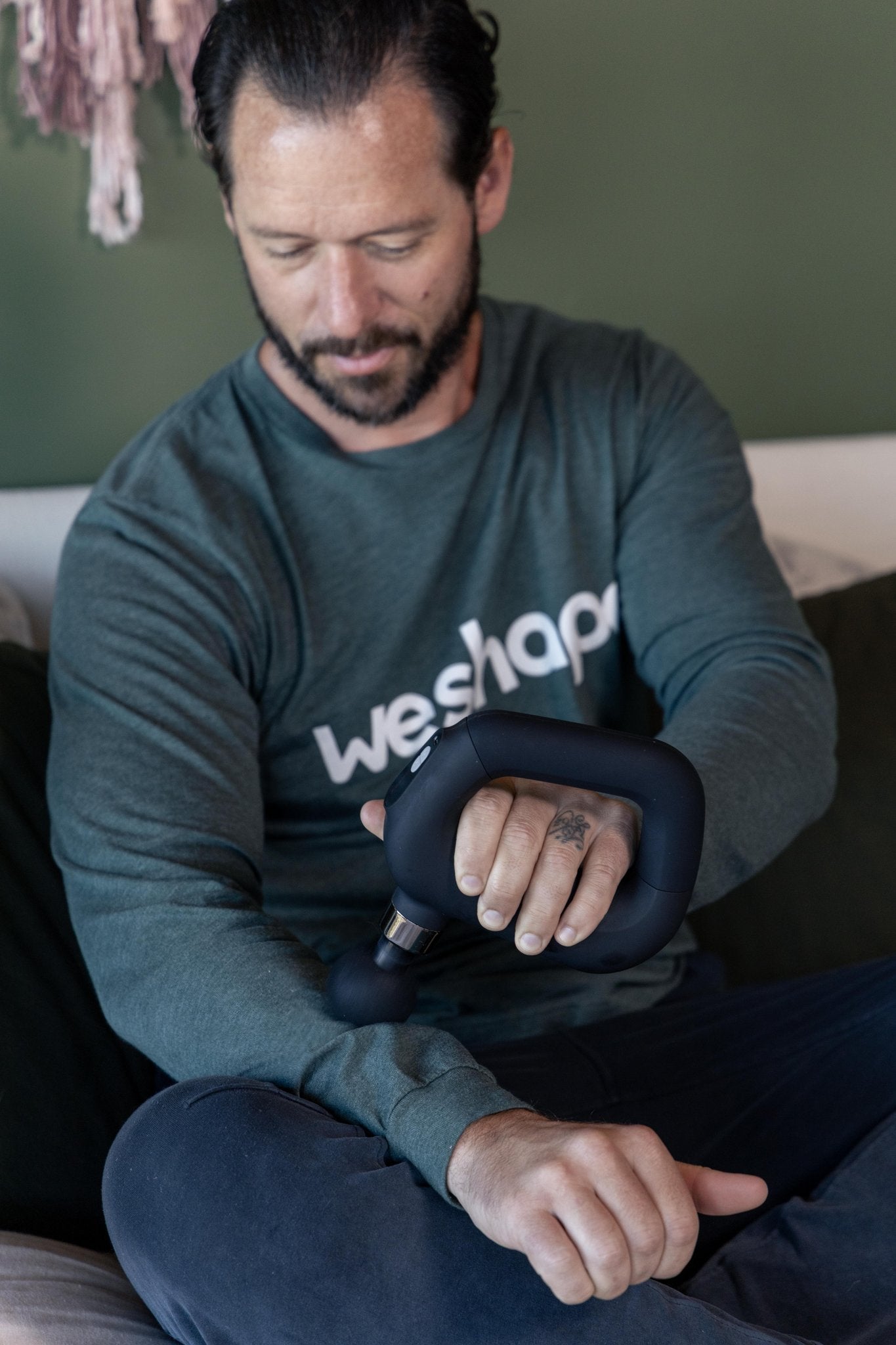 Tyler Using WeRevive percussion massage device